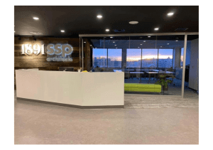 A look at the entrance to SSP Architectural Group's office with a receptionist desk, the SSP logo, and a conference room.