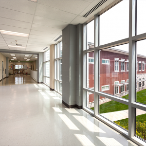 A glass hallway in a school designed by SSP Architects.