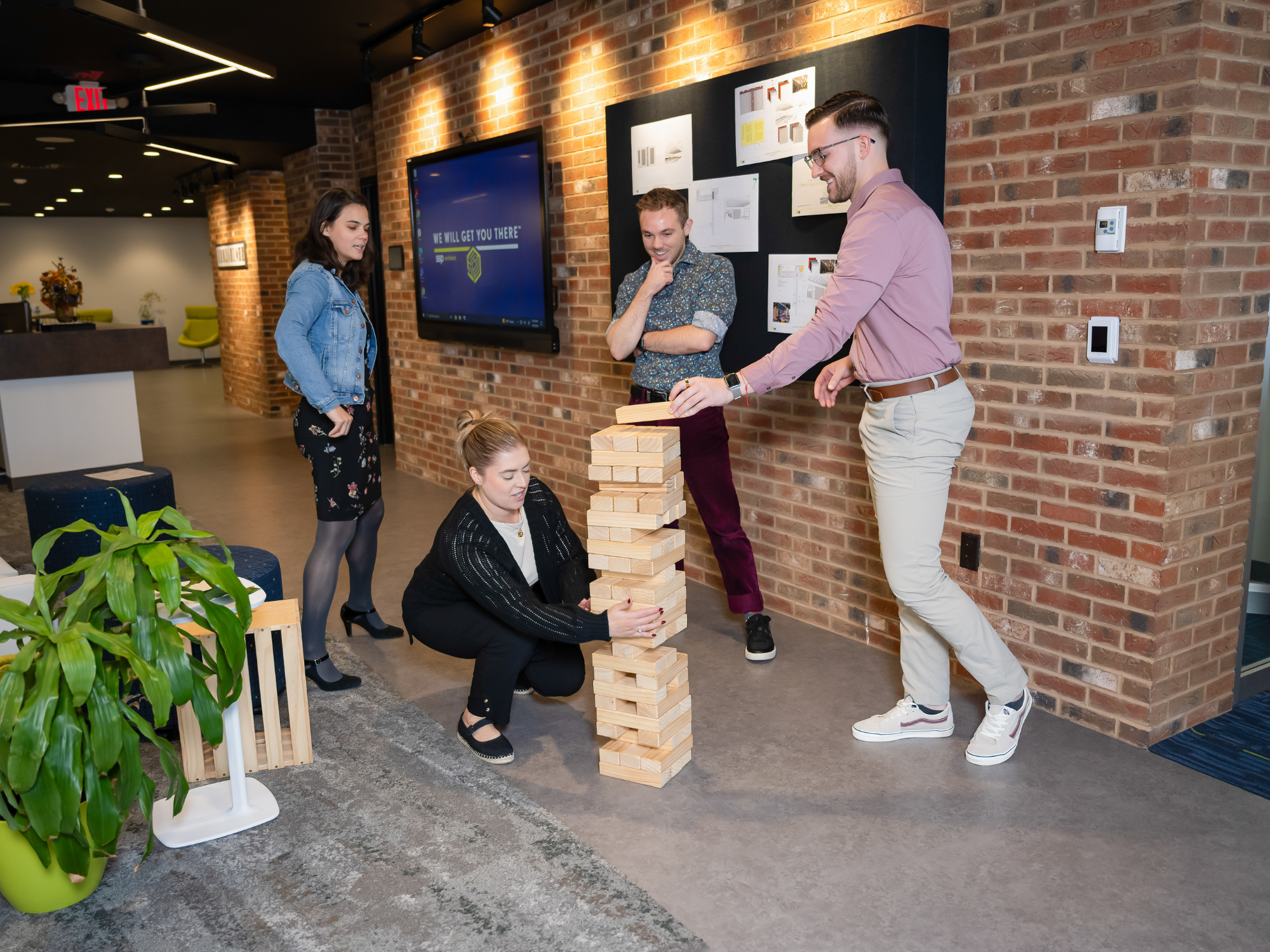 Group of people playing Jenga in the office